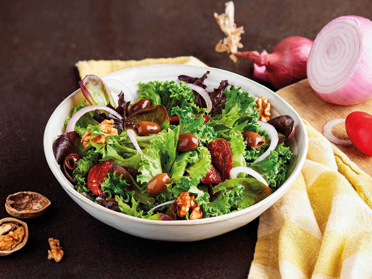Salat mit entsteinten Oliven, Zwiebeln und Walnüssen